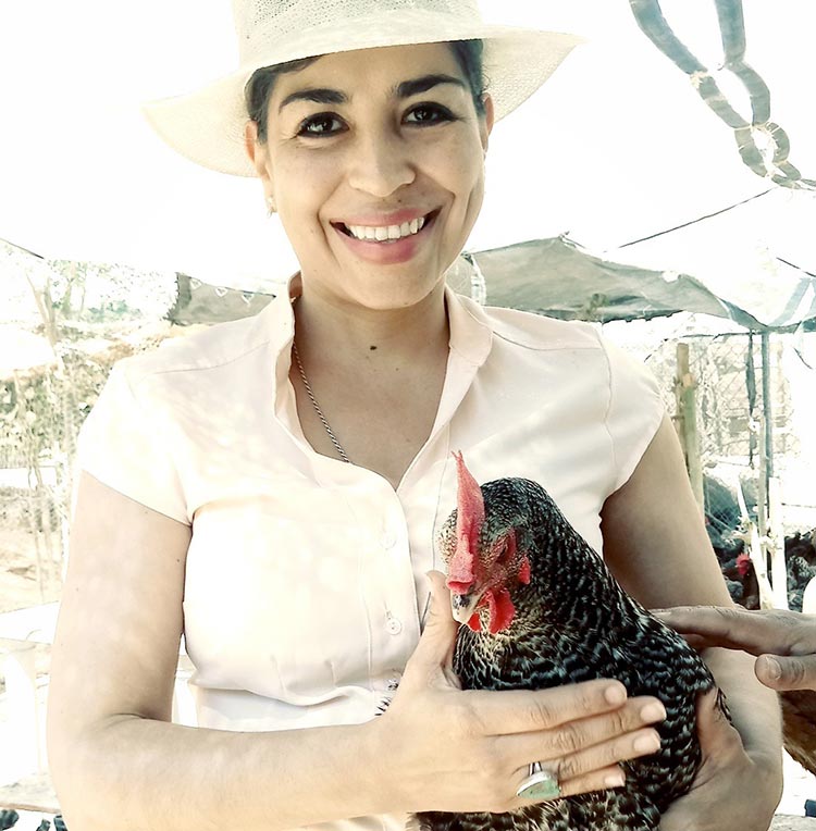 Eva holding a chicken