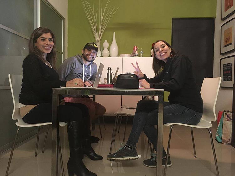 Eva sitting a table with co-workers