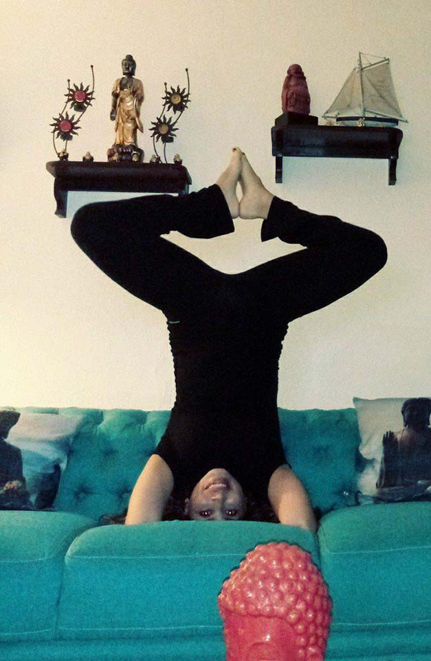 Eva doing a silly yoga pose on the couch